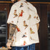 Person wearing a shirt with vintage-style pin-up girl illustrations.